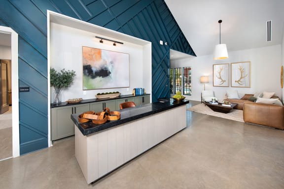 a kitchen with a counter and a living room at The Cottages at Old Monrovia Apartment, Huntsville, AL, 35806