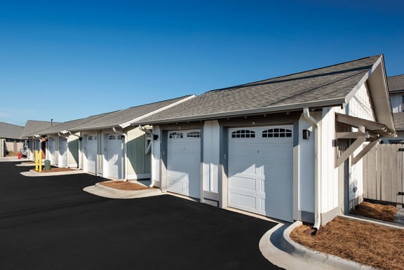 A parking lot with a building in the background at The Cottages at Old Monrovia Apartment , Alabama