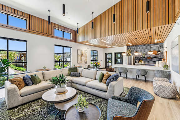 A modern living room with a wooden ceiling and white walls at The Arboretum Apartments, New York
