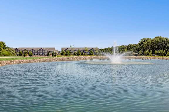 A fountain in the middle of a lake at The Arboretum Apartments, New York 11738