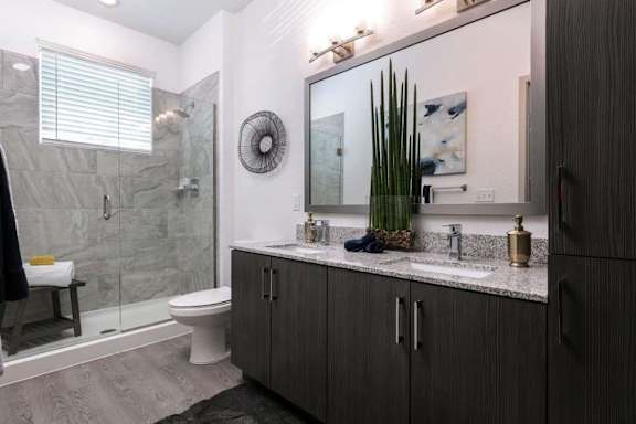 A bathroom with a toilet, sink, and shower.