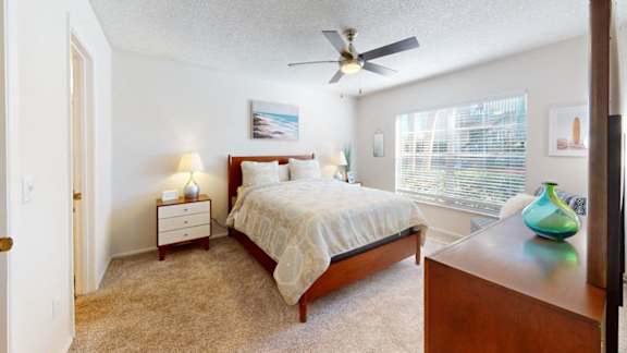 a bedroom with a bed and a ceiling fan at Somerset Apartments, Largo