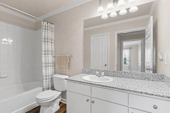 A bathroom with a white toilet, sink, and bathtub.