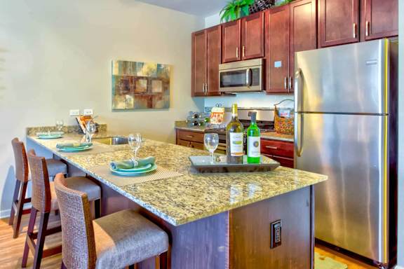 a kitchen with stainless steel appliances and a granite counter top at Wheaton 121, Wheaton, Illinois
