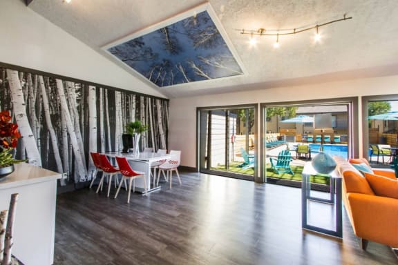 a living room and dining room with a table and chairs and sliding glass doors at Sundance and Sausalito Apartments, College Station, Texas