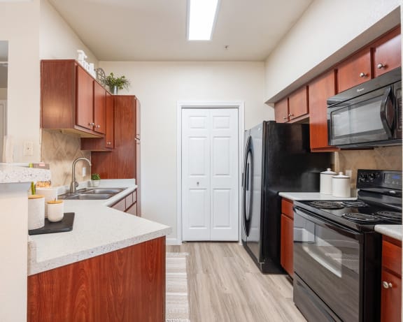 Kitchen with black appliances at Park Hudson Place Apartments, Bryan, 77802