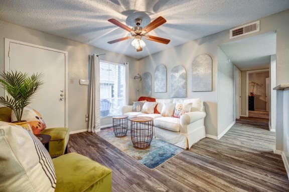 Living room with a ceiling fan and couch &#xA0;at Willowick Apartments, College Station, TX