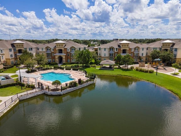 an aerial view of a swimming pool with apartments in the background