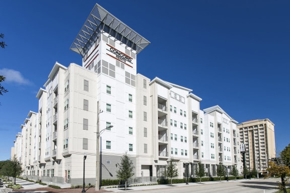 a large swimming pool with apartments in the background