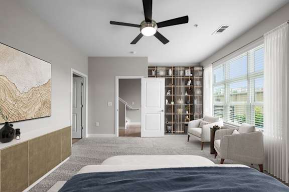 A bedroom with a large bed and a ceiling fan.