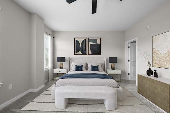 A bedroom with a large bed and a ceiling fan.