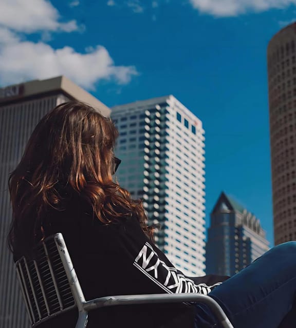 Woman Sitting Against Tampa Skyline