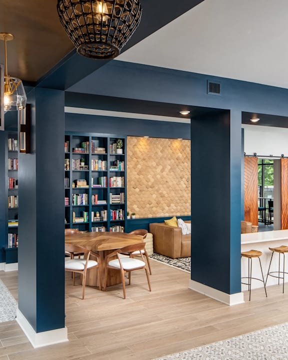 A modern living room with a wooden table and chairs.