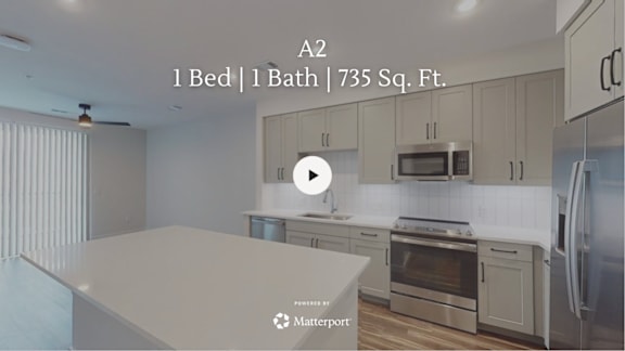 A kitchen with a countertop and stainless steel appliances.