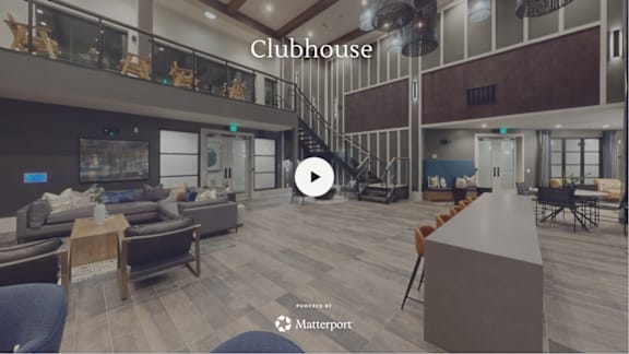 A modern clubhouse with a staircase and a bar area.
