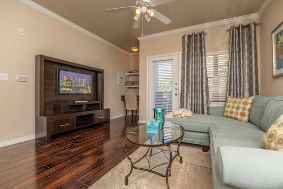 A living room with a television, a couch, and a coffee table.