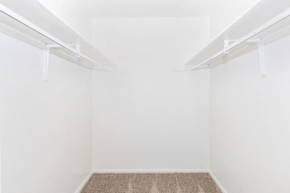 A room with white walls and a carpeted floor.
