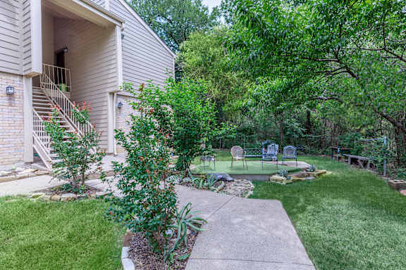 A house with a well-kept garden in front.