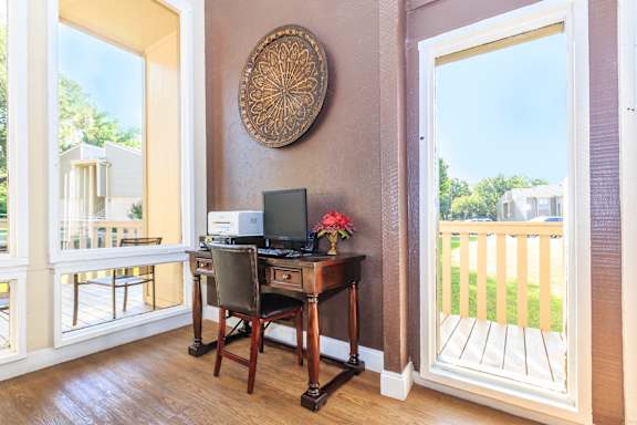 A room with a desk and a computer on it.