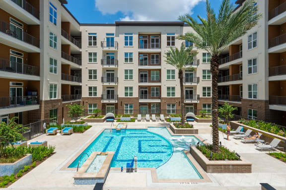 a swimming pool in front of an apartment building