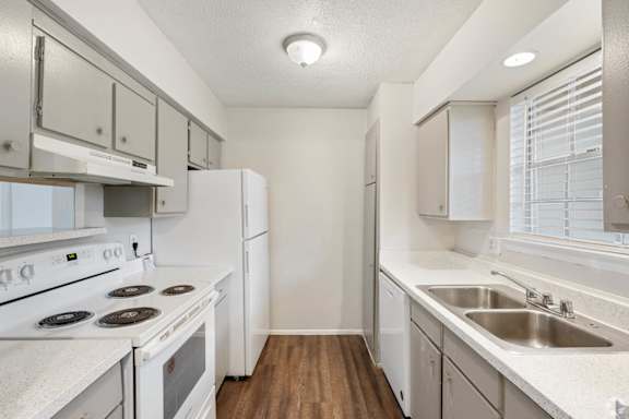 a kitchen with white appliances and white cabinets
