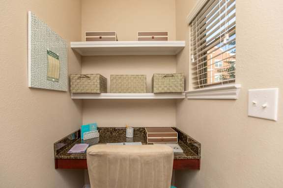A bathroom with a toiletries organizer and a towel on a table.