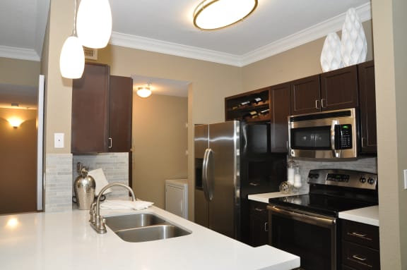a kitchen with stainless steel appliances and a white counter top
