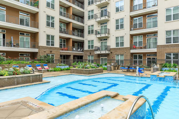 a swimming pool in front of an apartment building