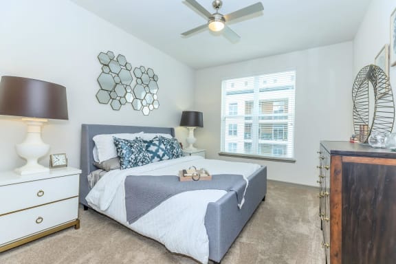 a bedroom with a bed and a ceiling fan