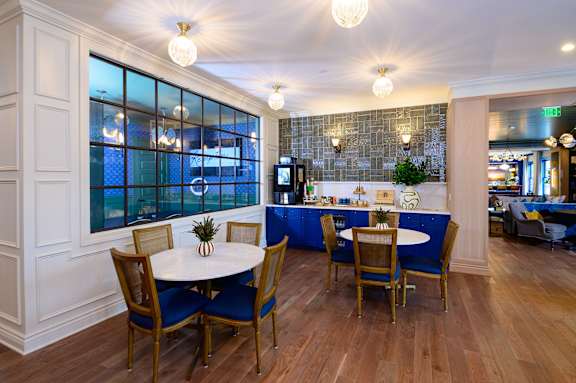 Clubhouse lounge with seating and complimentary coffee bar