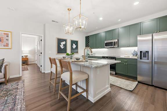 A kitchen with a table and chairs in the middle of it. at Maison Apartments, Westerville