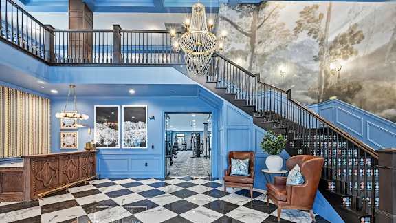 A blue and white checkered floor in a room with a staircase. at Maison Apartments, Ohio, 43081