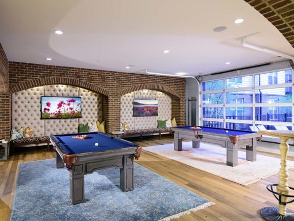 a game room with two pool tables