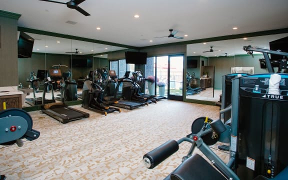 a room filled with lots of different types of exercise equipment at Fairfax, Grandview, 43212