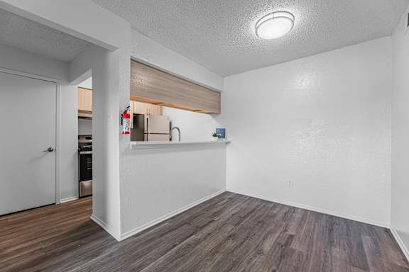 A room with a white wall and a wooden floor.