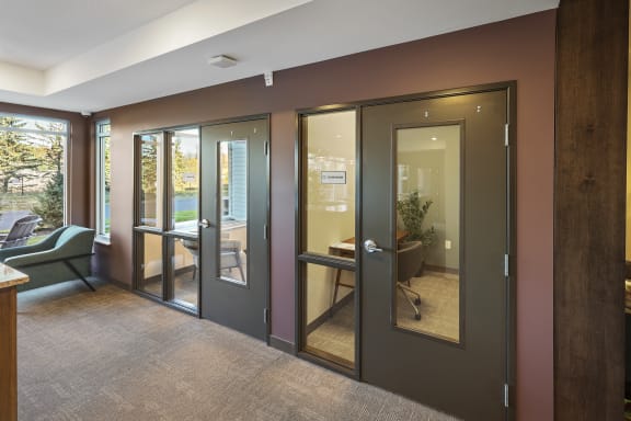 a conference room with sliding glass doors and a table and chairs