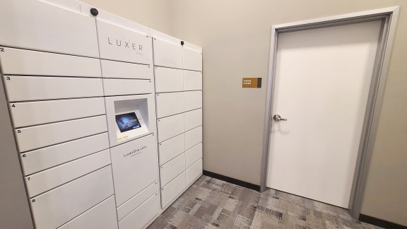 a white locker room with a white door and a door to the luckier room