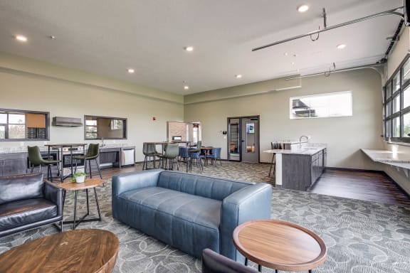 Community Room with a couch and tables and a kitchen