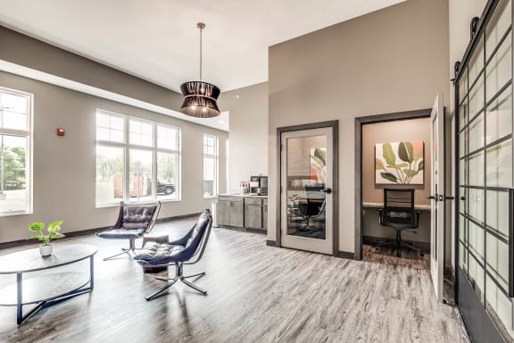 a living room with a table and chairs and a mirror