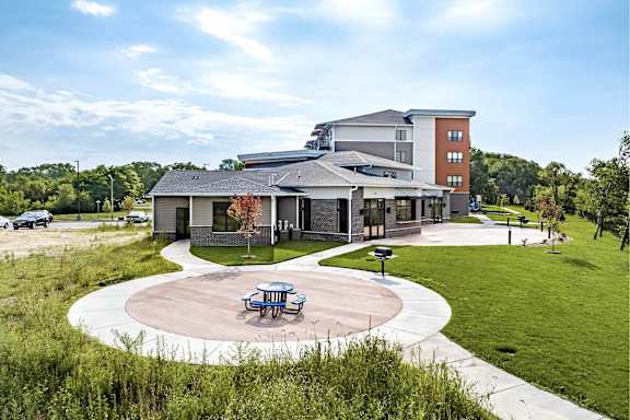 A modern building with a circular patio in front.
