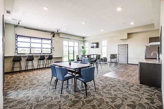 A conference room with a table and chairs.