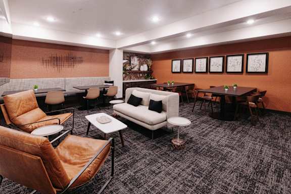 a lounge area with couches and chairs and tables