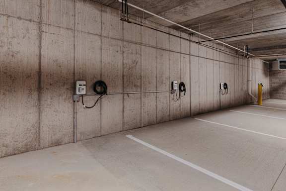 the inside of a parking garage with parking meters