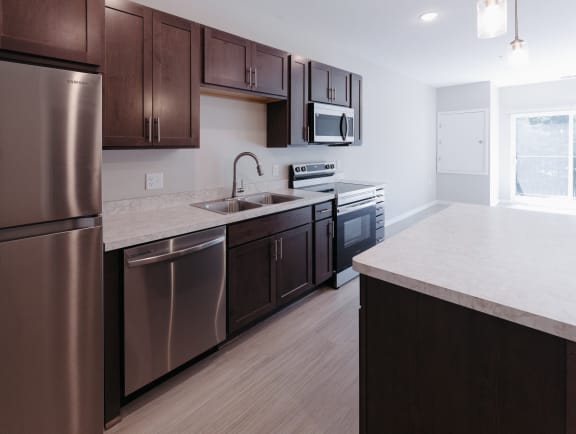 a kitchen with stainless steel appliances and a white counter top