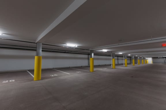 a parking garage with yellow pillars and white walls