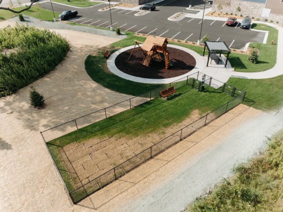 an aerial view of a playground in a parking lot