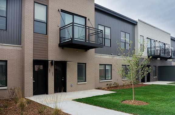 A modern two-story building with balconies at Alta Apartments, Pewaukee