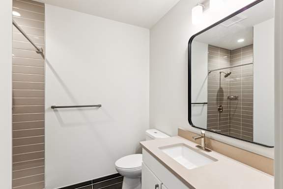 A white toilet sits next to a sink in a small bathroom.