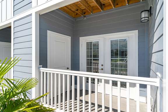 a house with blue siding and a wood ceiling