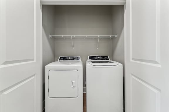 Two white washing machines in a laundry room at The Hendry Apartments, Fort Myers, 33905